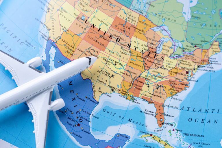 Map of the United States, Canada, and Mexico with a toy airplane, representing Amazon seller expansion into Canada and Mexico